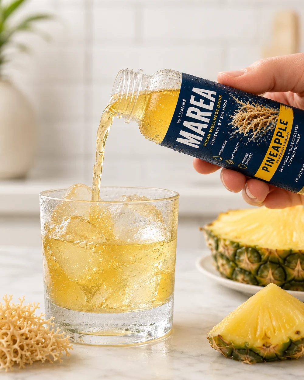 MAREA Pineapple sea moss drink being poured over ice